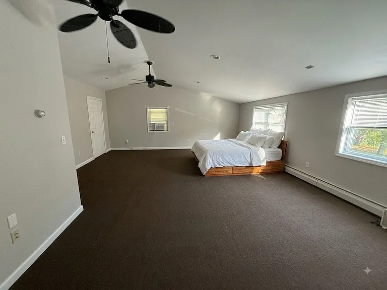 Primary bedroom with walk-in closet and ensuite bathroom.