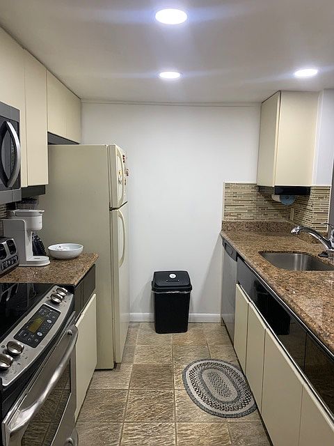 Kitchen side view with granite counter tops.