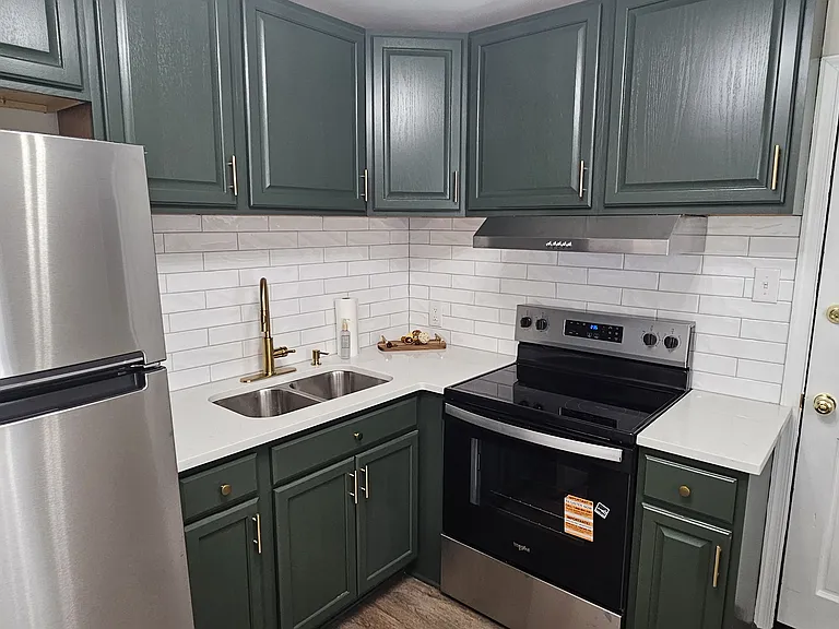 Newly renovated kitchen with new backsplash, flooring, appliances, fixtures and cabinets