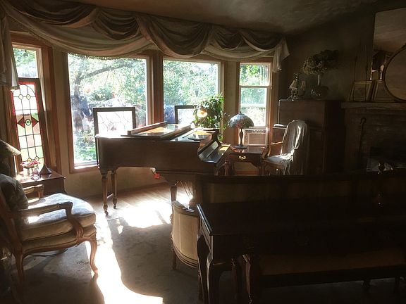 Living room with recently refurbished baby grand. 