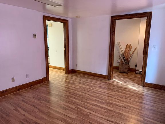Living room. Door on right brings you to the front entrance and hallway, door on the left leads you into the kitchen.