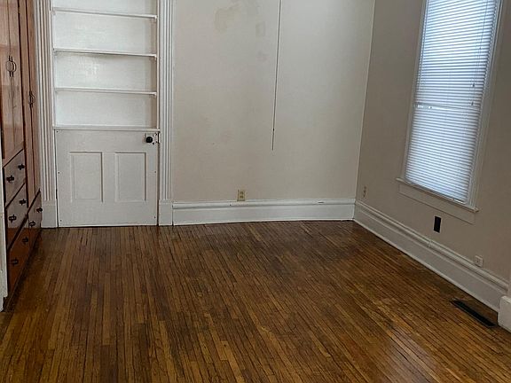 Main level bedroom with built in drawers and closets. Hardwood floor. ceiling fan