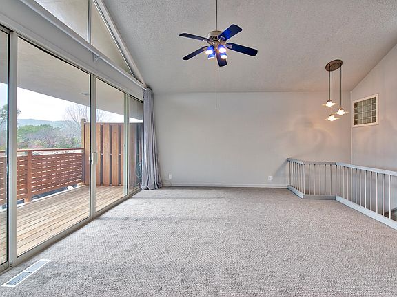 Living room with sliders that open out to large deck.