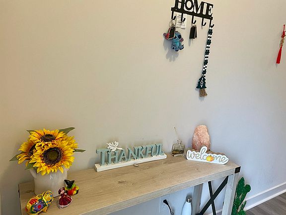 Foyer table. Personal items will be removed prior to move-in date.