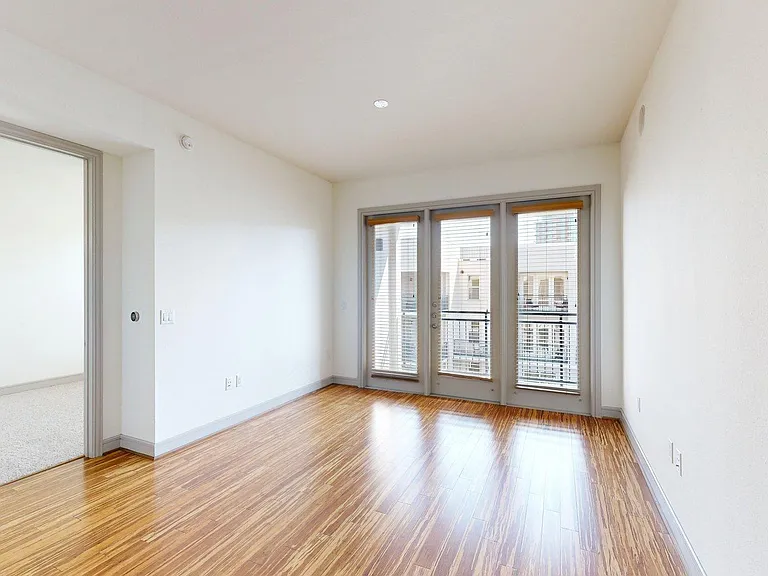 Apartment living room with wood style floor.