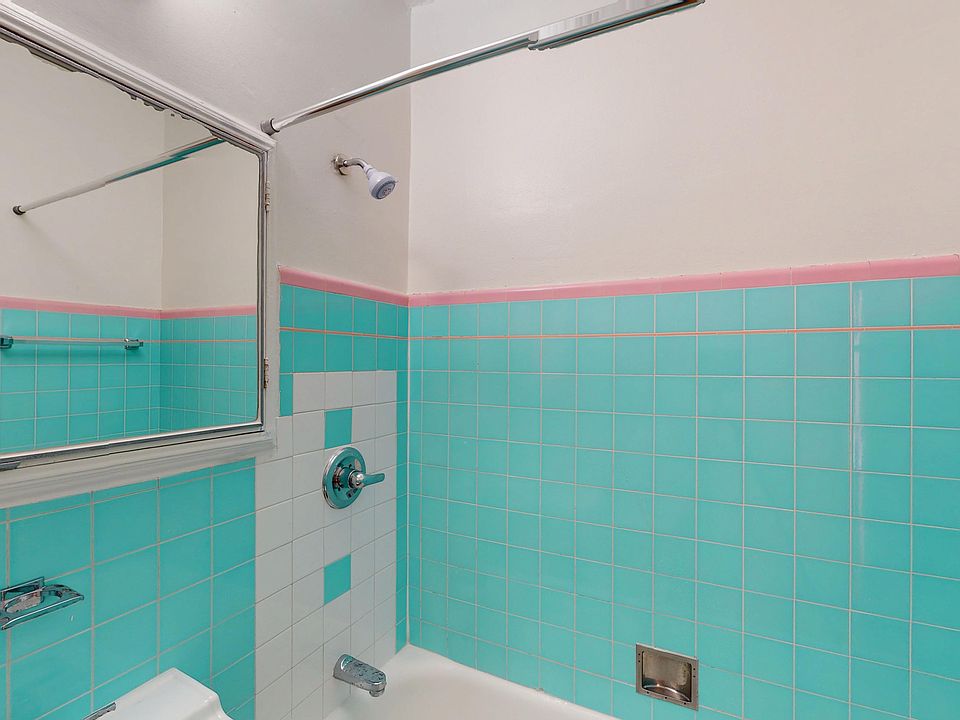 Bathroom featuring a showerhead, and a mirror reflecting the space