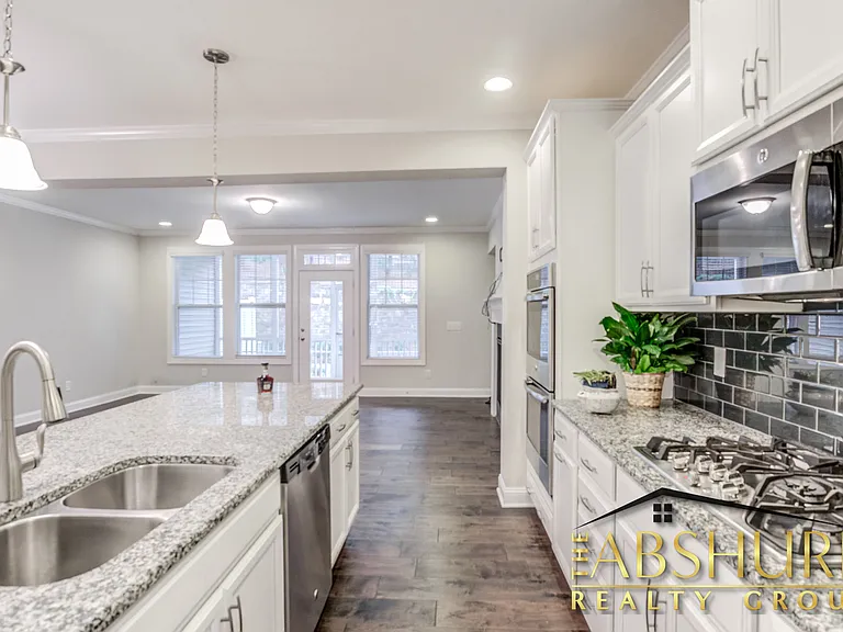 Luxurious open concept kitchen w/ oversized island, granite countertops, SS appliances, 2 wall ovens