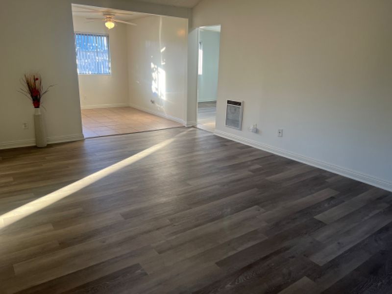 We are in the living room going towards the dining room and door to the right going to the small hallway where bathroom is and the 2 bedrooms