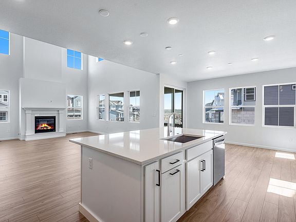 Kitchen overlooking great room with fireplace