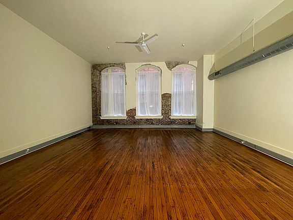 Exposed brick, hardwood floors and floor to ceiling windows.