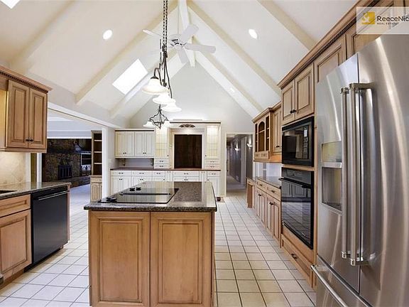 Bright, airy kitchen with loads of sunshine from skylights and wall of windows in sunroom.