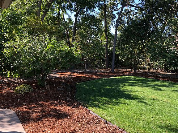 Fenced backyard with areas to play.