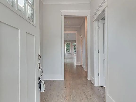 Entrance with 1bedroom on right, full bathroom, coat closet, and kitchen living