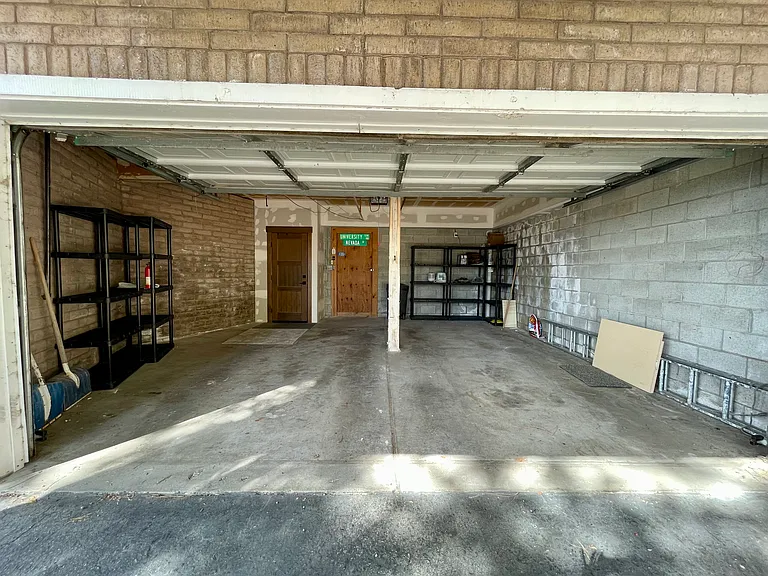 2-car garage with storage room, interior home access, and automatic roll-up garage door