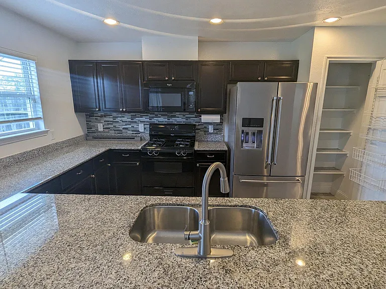 Upgraded kitchen, ample storage cabinets and pantry.