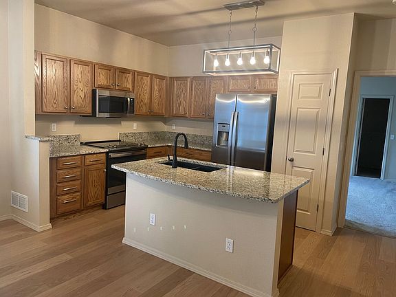 Spacious kitchen with 6-month old appliances. New granite countertops. Black sink. Room for bar stools.