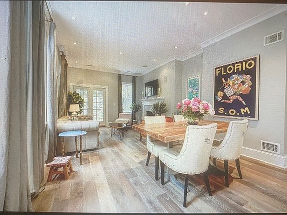 Dining area sports French oak hardwood flooring and open room concept