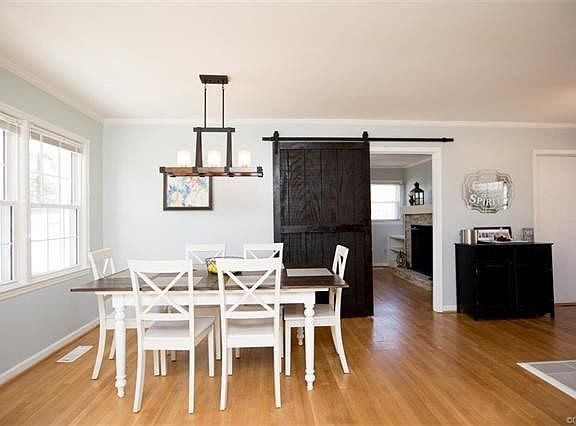 Dining Room with Wood floors extending through doorway into living room
