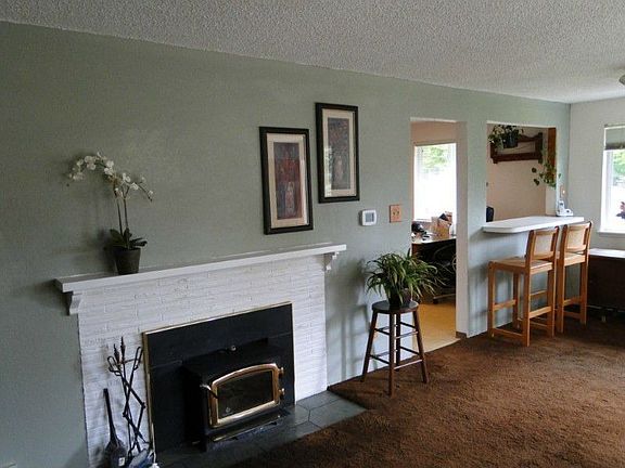 Cozy wood burning insert adds ambiance and warmth. Newer white, vinyl thermal windows thruout. Hardw