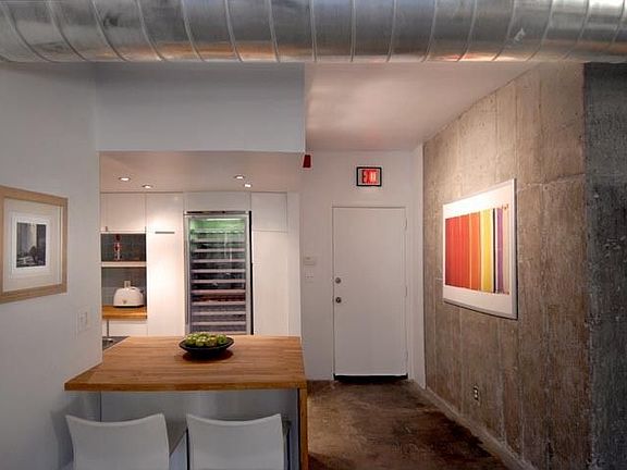 exposed concrete wall & wine fridge