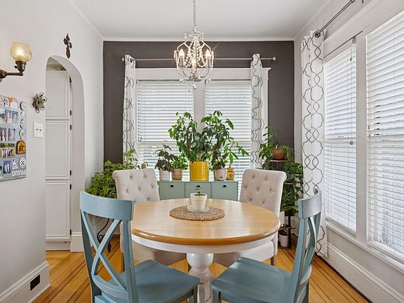 Dining room. Full kitchen is off to the left. If you're a plant-parent, this is a dream come true. So much natural light, which can easily be modified with blinds or curtains. Gorgeous unobstructed view of the backyard oasis and pond + waterfall feature.