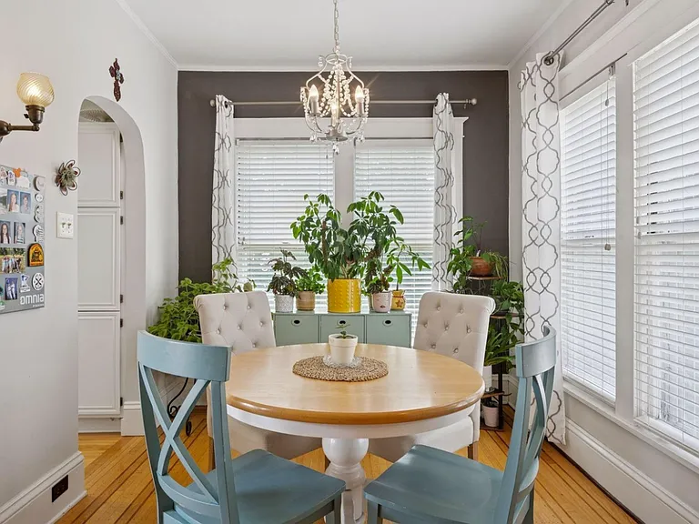 Dining room. Full kitchen is off to the left. If you're a plant-parent, this is a dream come true. So much natural light, which can easily be modified with blinds or curtains. Gorgeous unobstructed view of the backyard oasis and pond + waterfall feature.