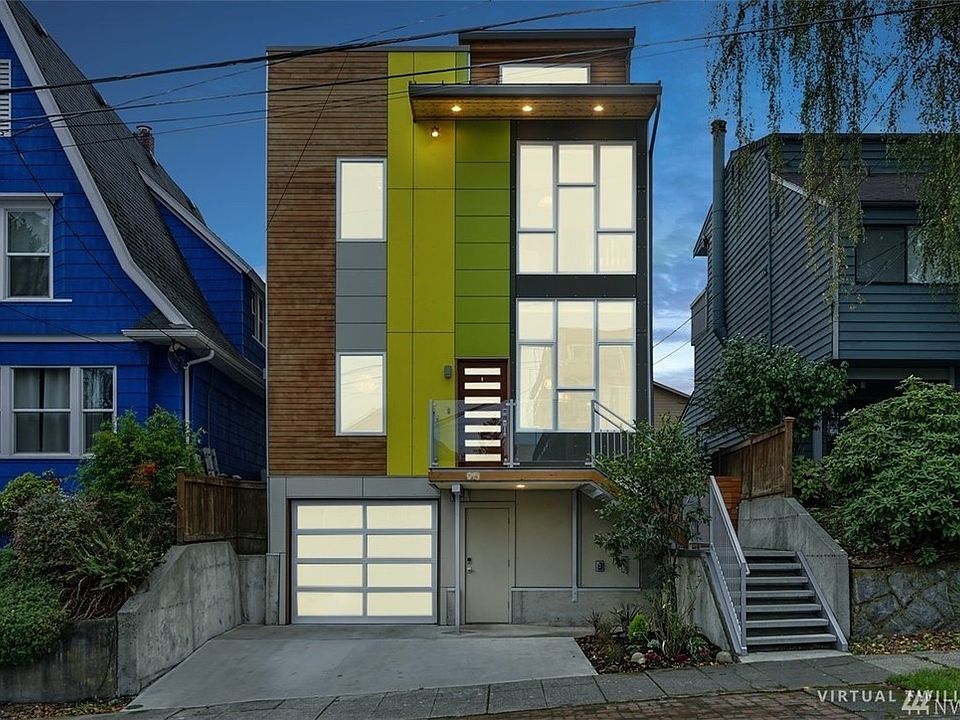 Modern Greenlake smart home with rooftop deck, Lake and Mt. Rainier views, cedar siding, metal roof, and modern and vibrant colors. Steps to Green Lake in a prime location!