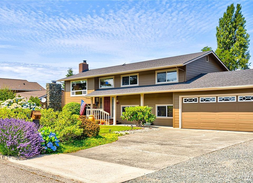 Desirable, level lot with 2-car garage, lawn and mature plantings. Covered entrance to protect against weather. Extra driveway; Park RV/Trailer, boat & toys!