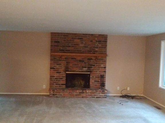Large living room with wood burning fireplace