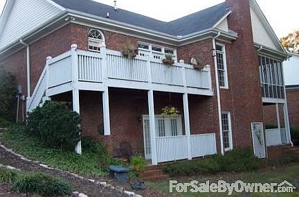 Back of house, surprising isn't it?
						:
						Large deck off kitchen,covered porch off bedroom downstairs opens to golf course