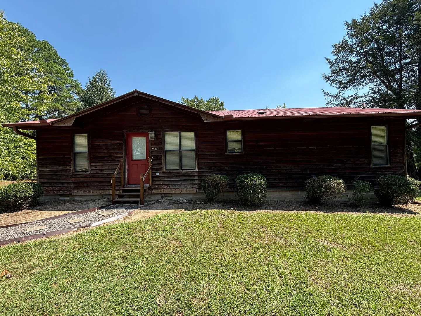 Located on the outskirts of Russellville, this three-bedroom, two-bath home — Photo 1