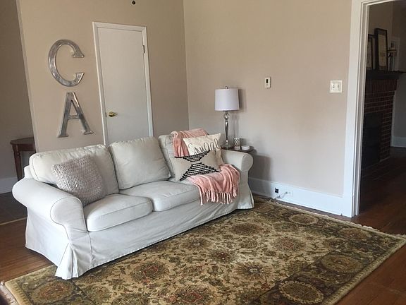 Living room with large coat closet and shelving for incredib