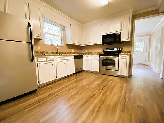 Kitchen includes dish washer and stainless steel appliances