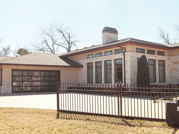 The oversized three car garage has glass panels, allowing natural light to pour into the space.