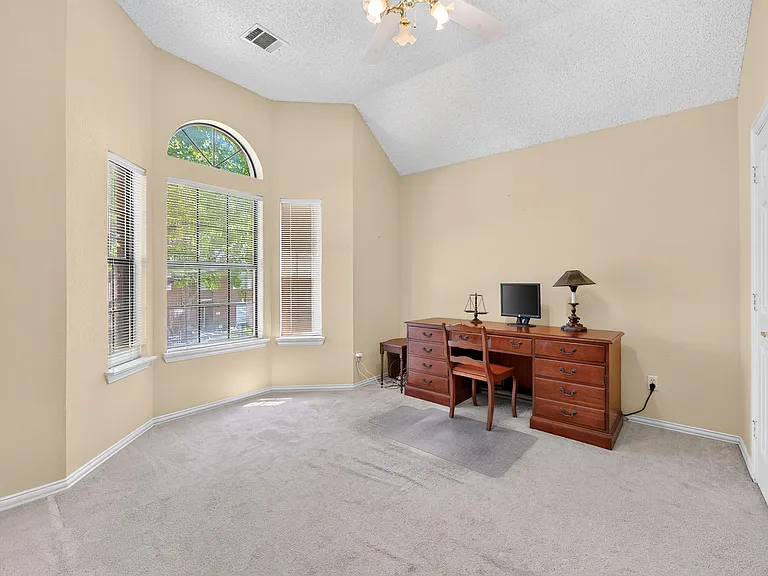 Bedroom with bay window, vaulted ceiling, ceiling fan