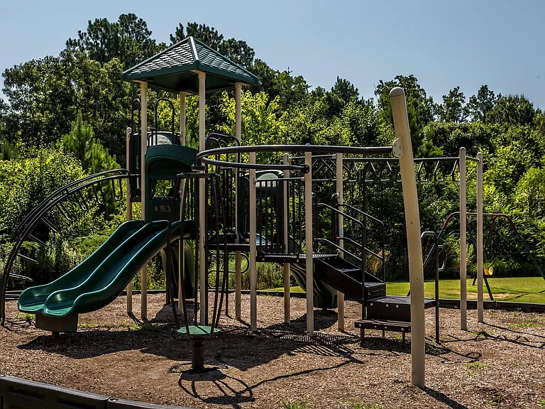 Explore this delightful playground nestled in a verdant setting, perfect for kids' adventures.