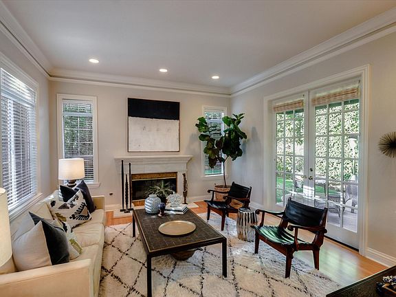 Formal Living with French doors that open to a flat backyard