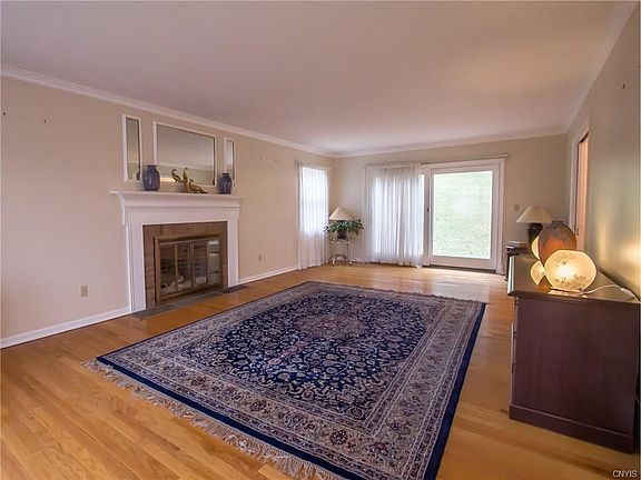 To the left of the foyer you are welcomed into the large formal living room with wood burning fireplace and sliders to the patio.