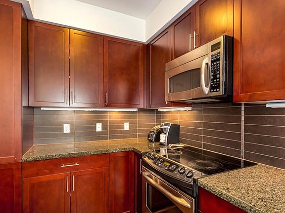 Cherry cabinets, stainless steel appliances.