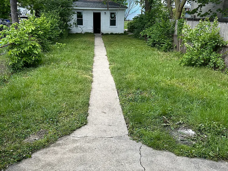 solid sized fenced in backyard with a 2 car detached garage.