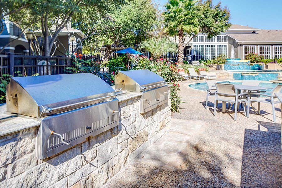Charcoal BBQ Pits by pool and table seating
