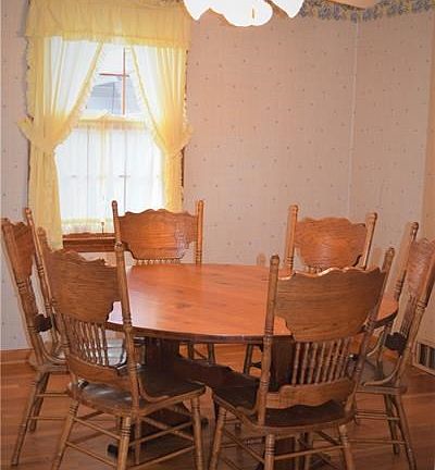 Dinning room with hardwood floors and lighted ceiling fan. Great for dinning.