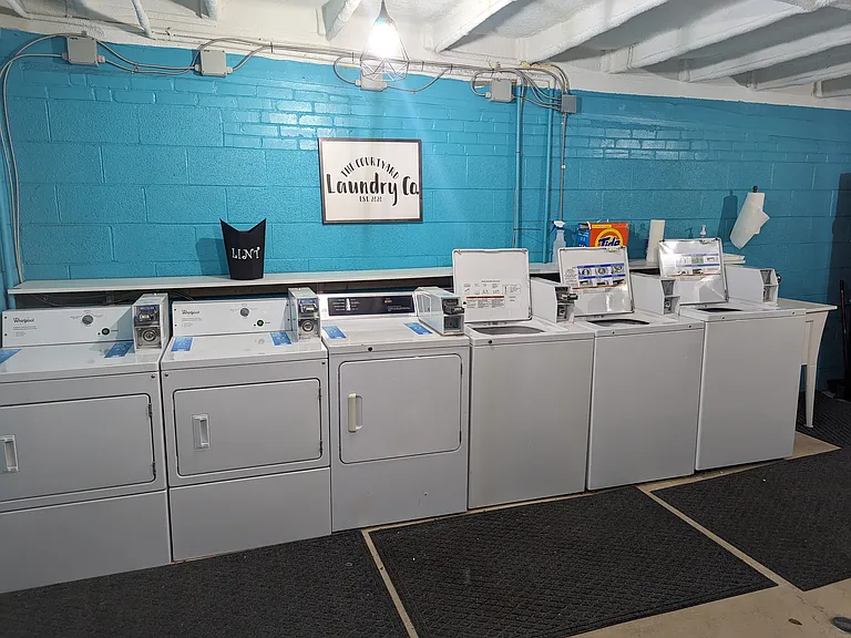 Clean on site laundry facility with multiple machines, making laundry day simple and convenient for residents.