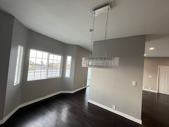 Dining room with chandelier and bay windows