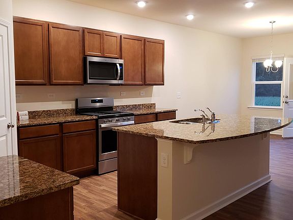 Large kitchen with dining that has views of woods and farm