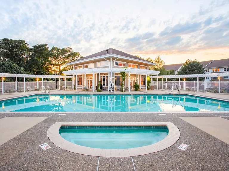 Resort-Style Pool with Pergola and Chaise Lounge Seating