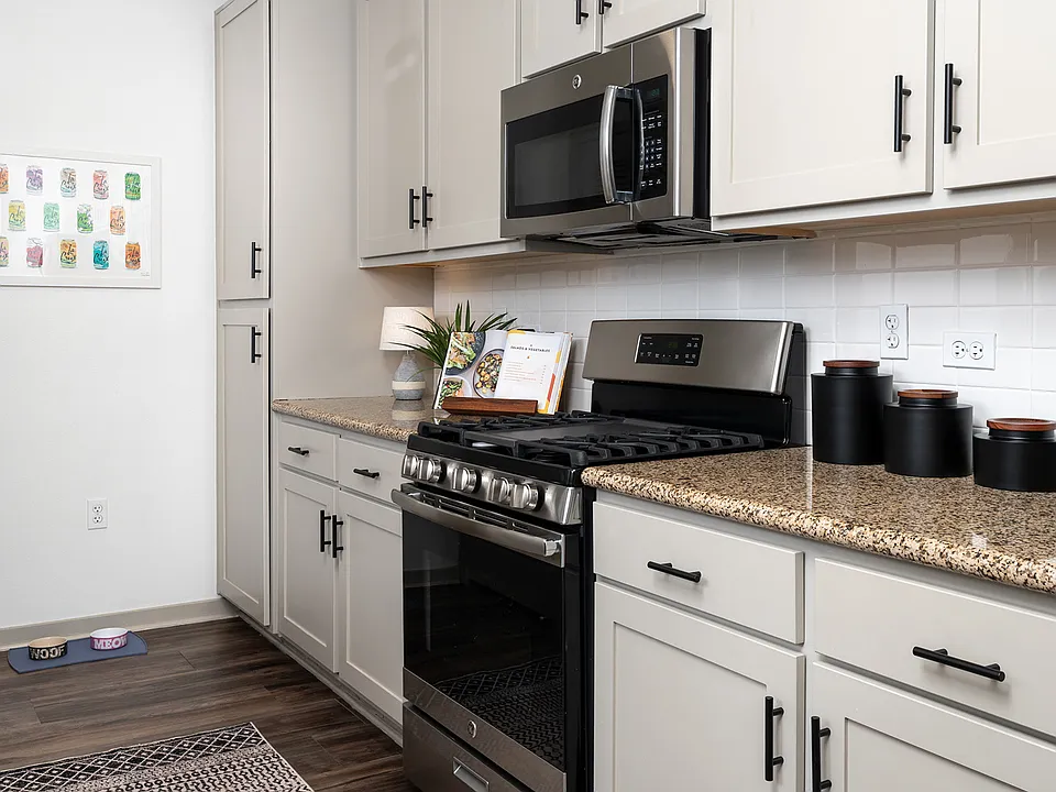 Brand new backsplash and hardware on the shaker-style cabinets