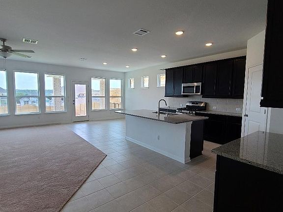 Open floor plan with kitchen, dining and living area.
