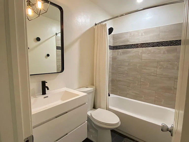 updated bathroom with 36" floating vanity and all new, matte black fixtures