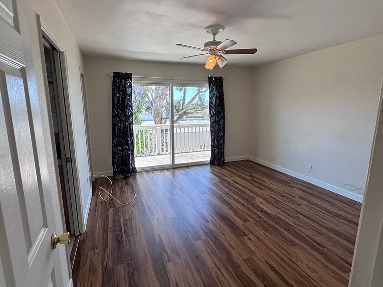 Primary Bedroom with large slider doors to Balcony